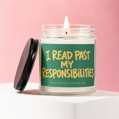Glass candle with lit wick and green label that reads "I READ PAST MY RESPONSIBILITIES."