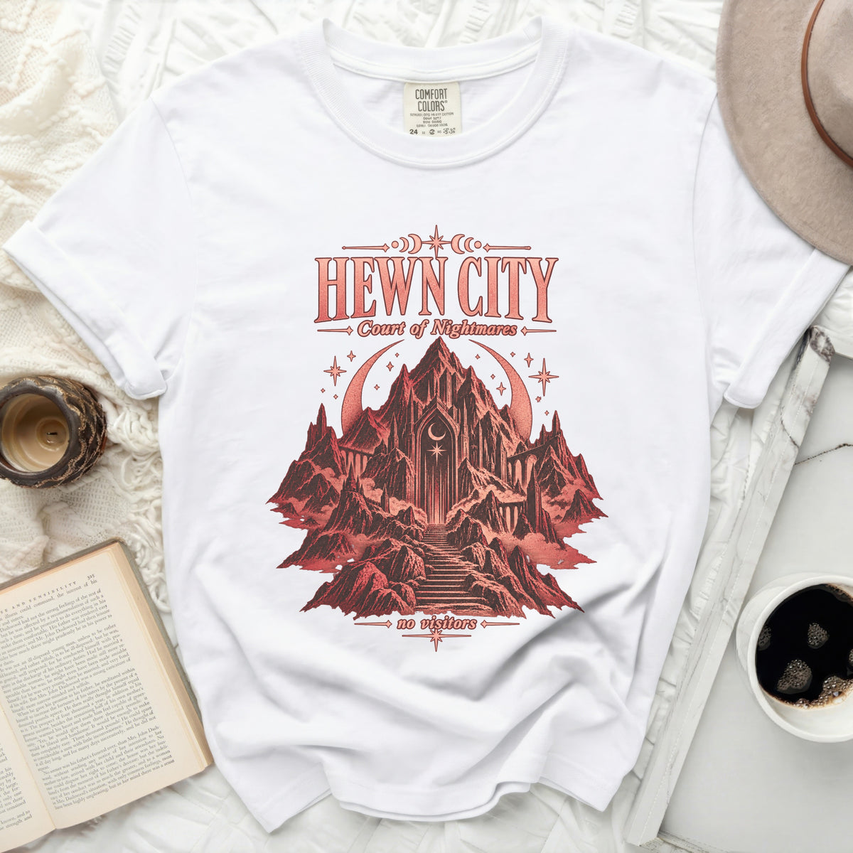 White t-shirt with "HEWN CITY Court of Nightmares" and castle graphic.