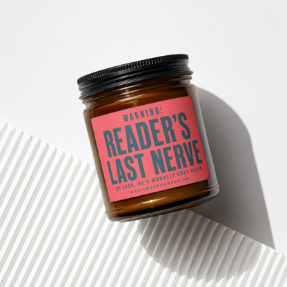 Amber jar candle with black lid and red label reading "Reader's Last Nerve".