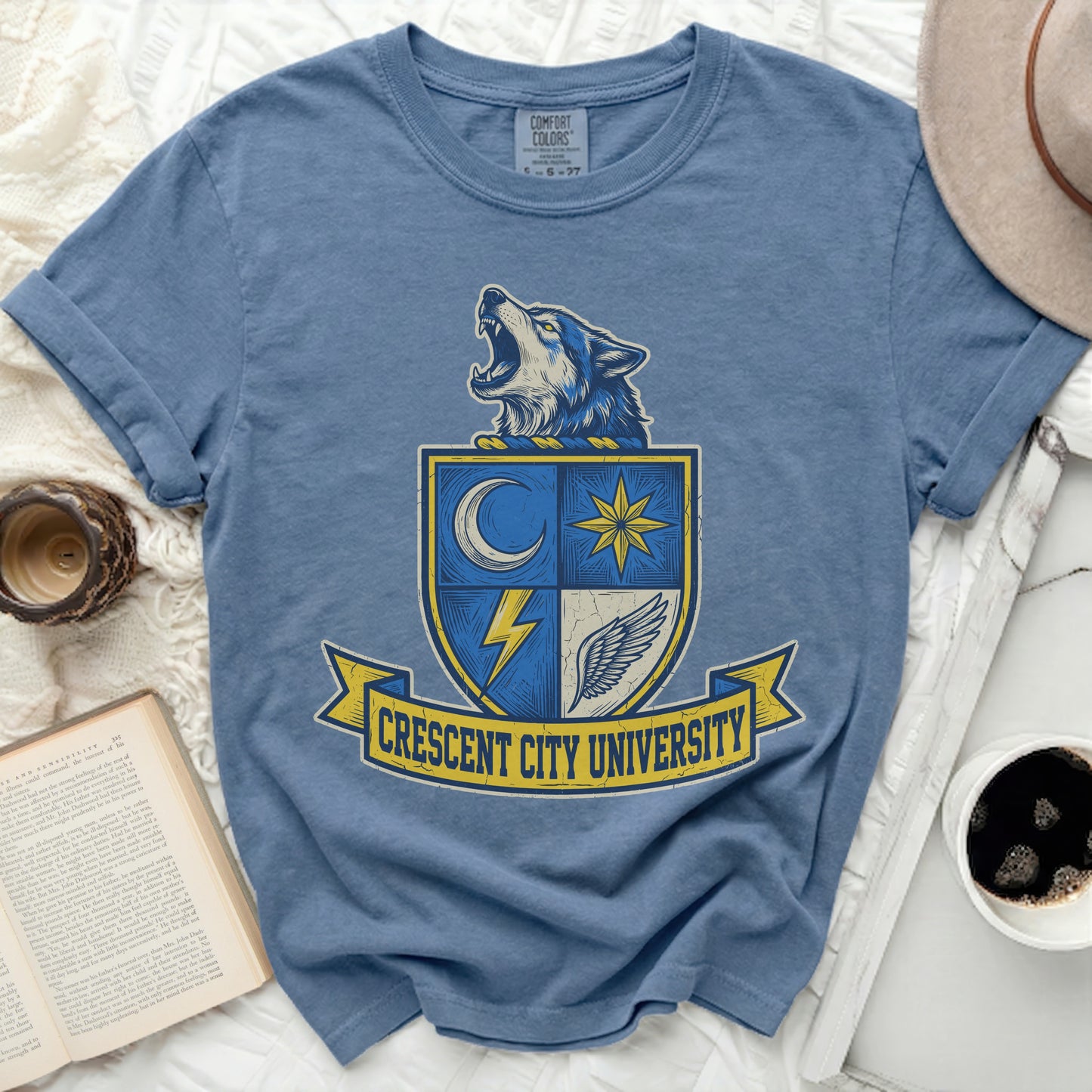 Blue t-shirt with Crescent City University shield logo featuring a wolf.