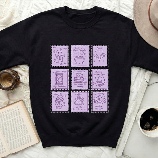 Black sweatshirt with nine pastel purple stamp graphics featuring reading and spooky themes.
