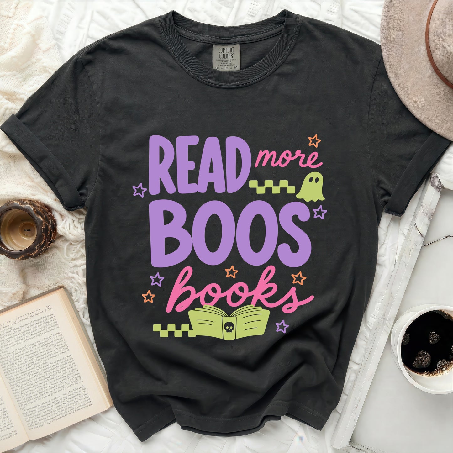 Dark t-shirt with purple and pink Halloween graphic that says "Read More Boos Books."