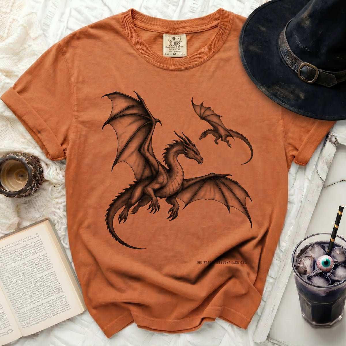 Orange t-shirt with black dragon graphic and text "YOU WANT A DRAGON? EARN ONE."