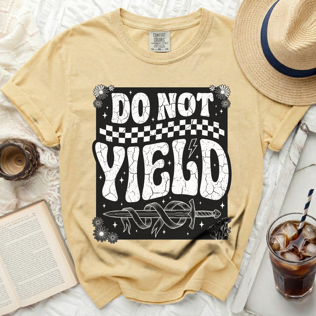 Yellow t-shirt with "DO NOT YIELD" text, sword, and flowers graphic.