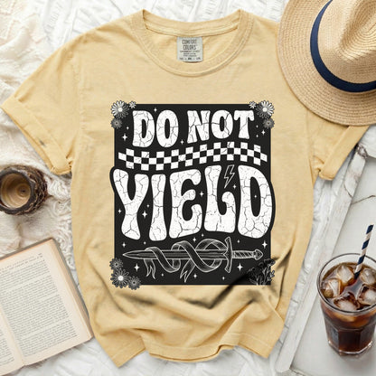 Yellow t-shirt with "DO NOT YIELD" text, sword, and flowers graphic.