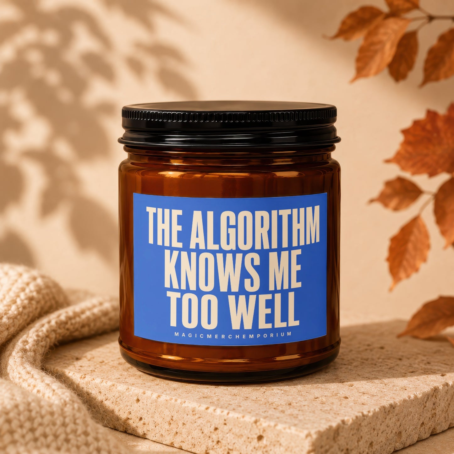 Brown glass candle in amber jar with blue label reading "THE ALGORITHM KNOWS ME TOO WELL."