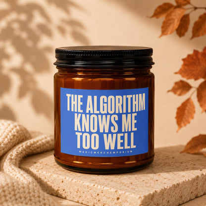 Brown glass candle in amber jar with blue label reading "THE ALGORITHM KNOWS ME TOO WELL."