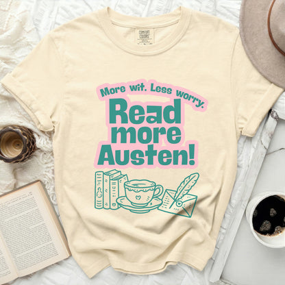 Cream t-shirt with pink and teal text: "More wit. Less worry. Read more Austen!"