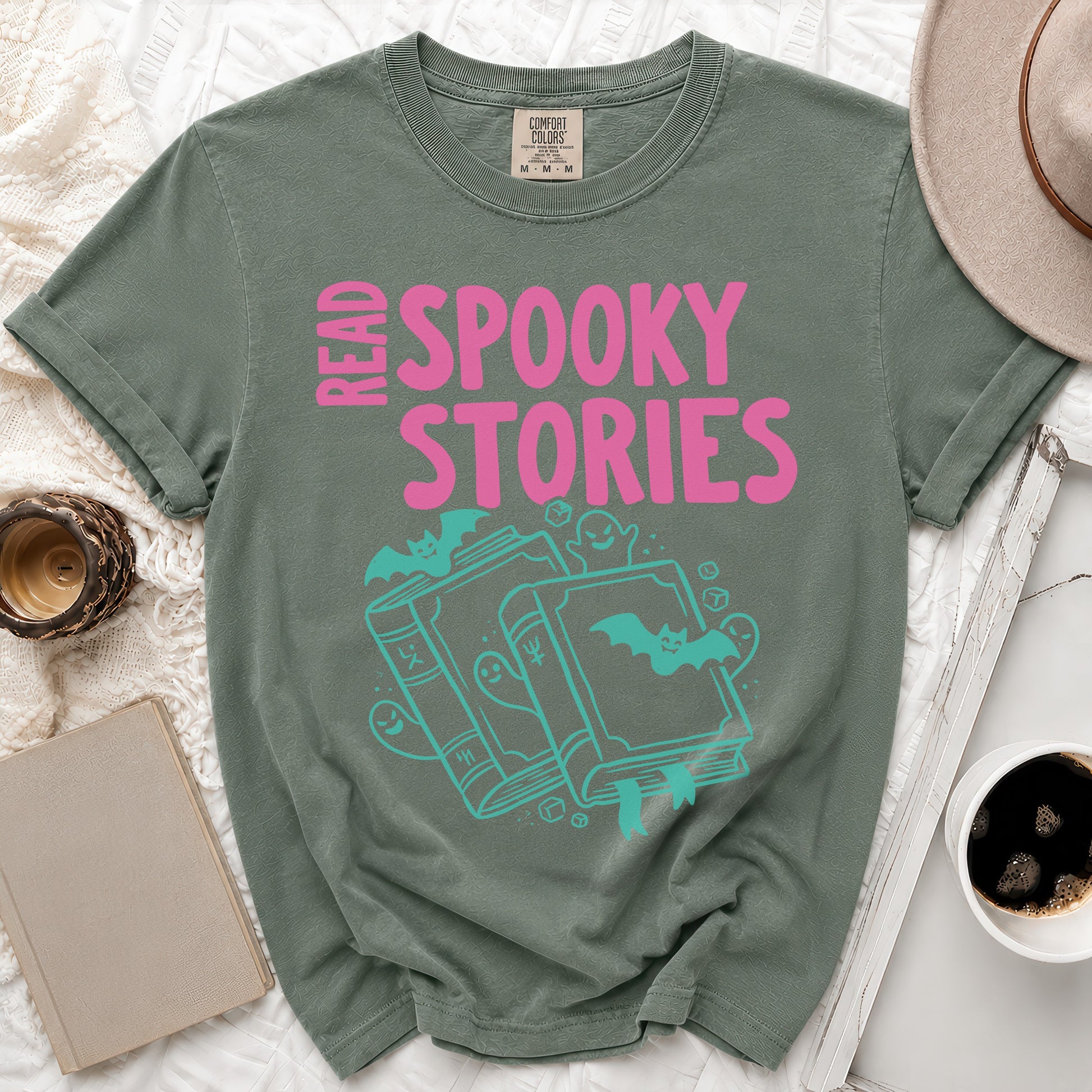 Green t-shirt with pink "READ SPOOKY STORIES" text and turquoise Halloween illustrations.