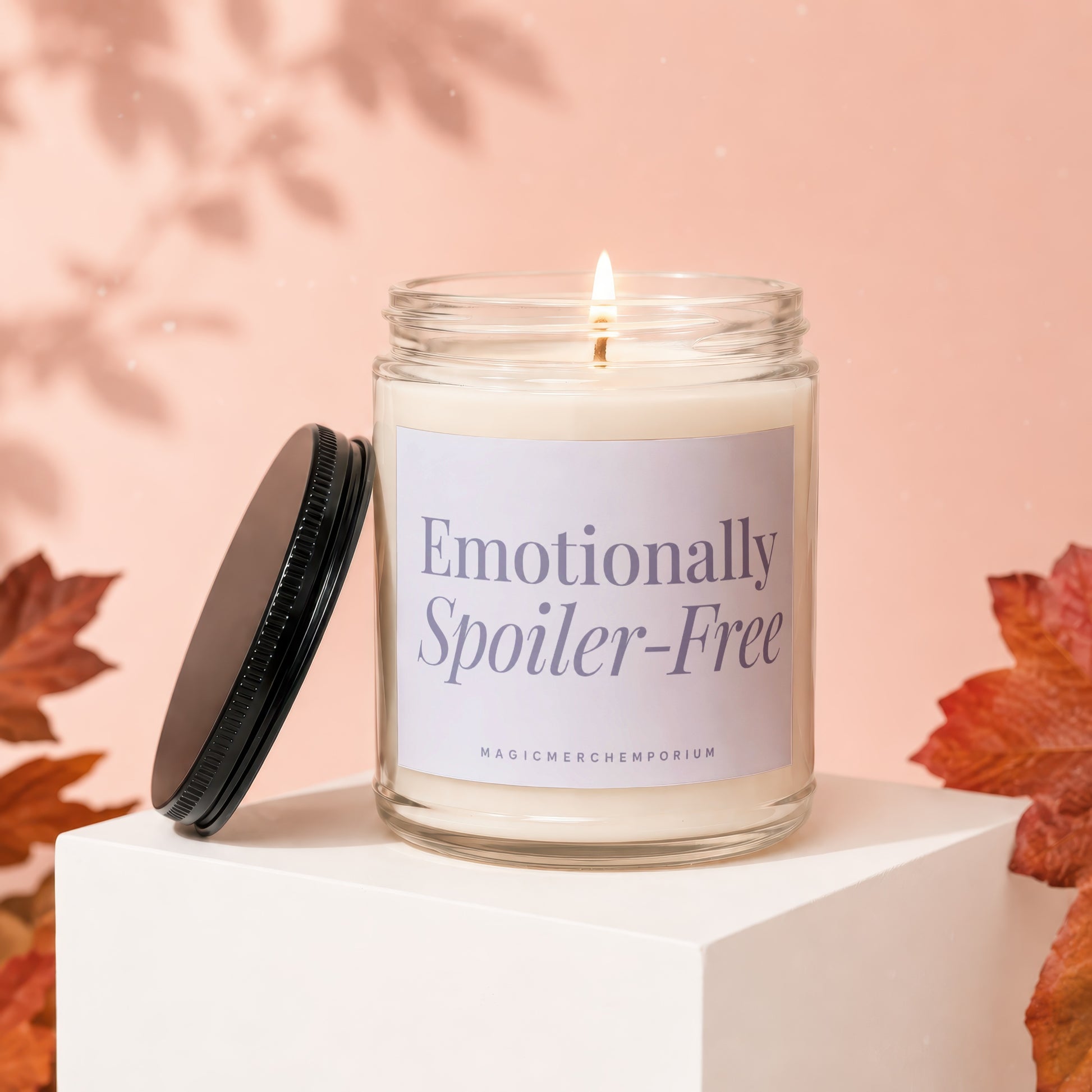 Lit candle in glass jar with "Emotionally Spoiler-Free" text on label.