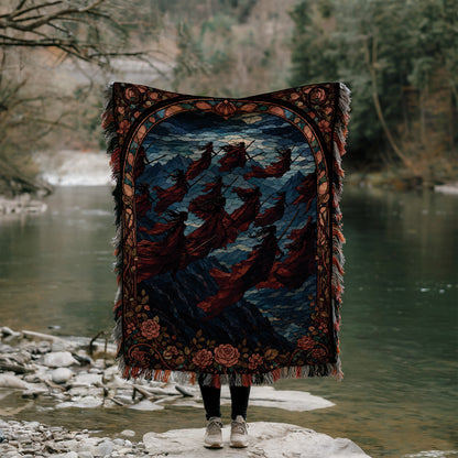 A person stands on a rock, holding a large, colorful rug with a floral design, partially obscuring their face.