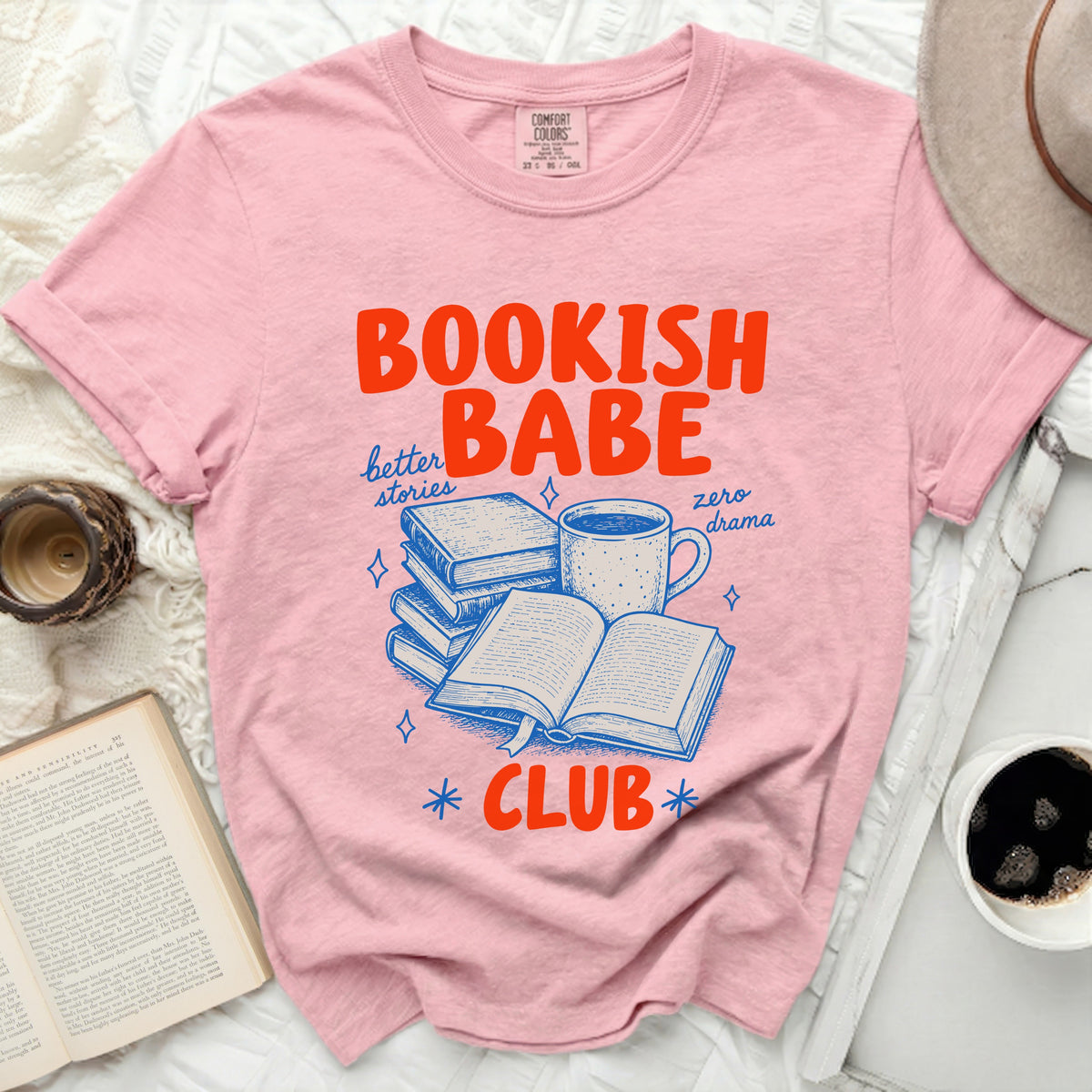 Pink t-shirt with "Bookish Babe Club" graphic featuring books and coffee.