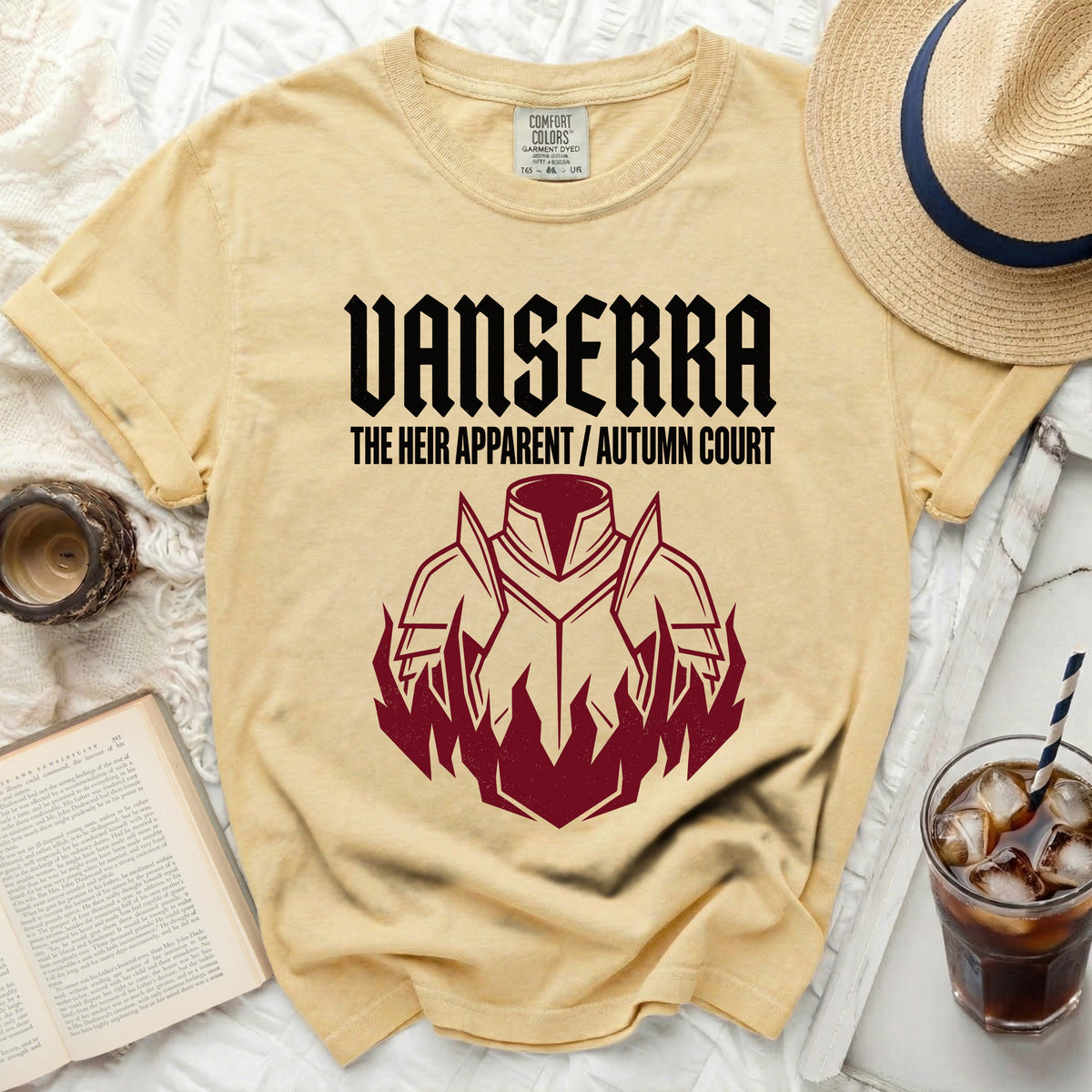 Yellow shirt with black text "VANSERRA THE HEIR APPARENT / AUTUMN COURT" and armor graphic.