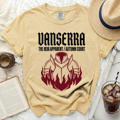 Yellow shirt with black text "VANSERRA THE HEIR APPARENT / AUTUMN COURT" and armor graphic.