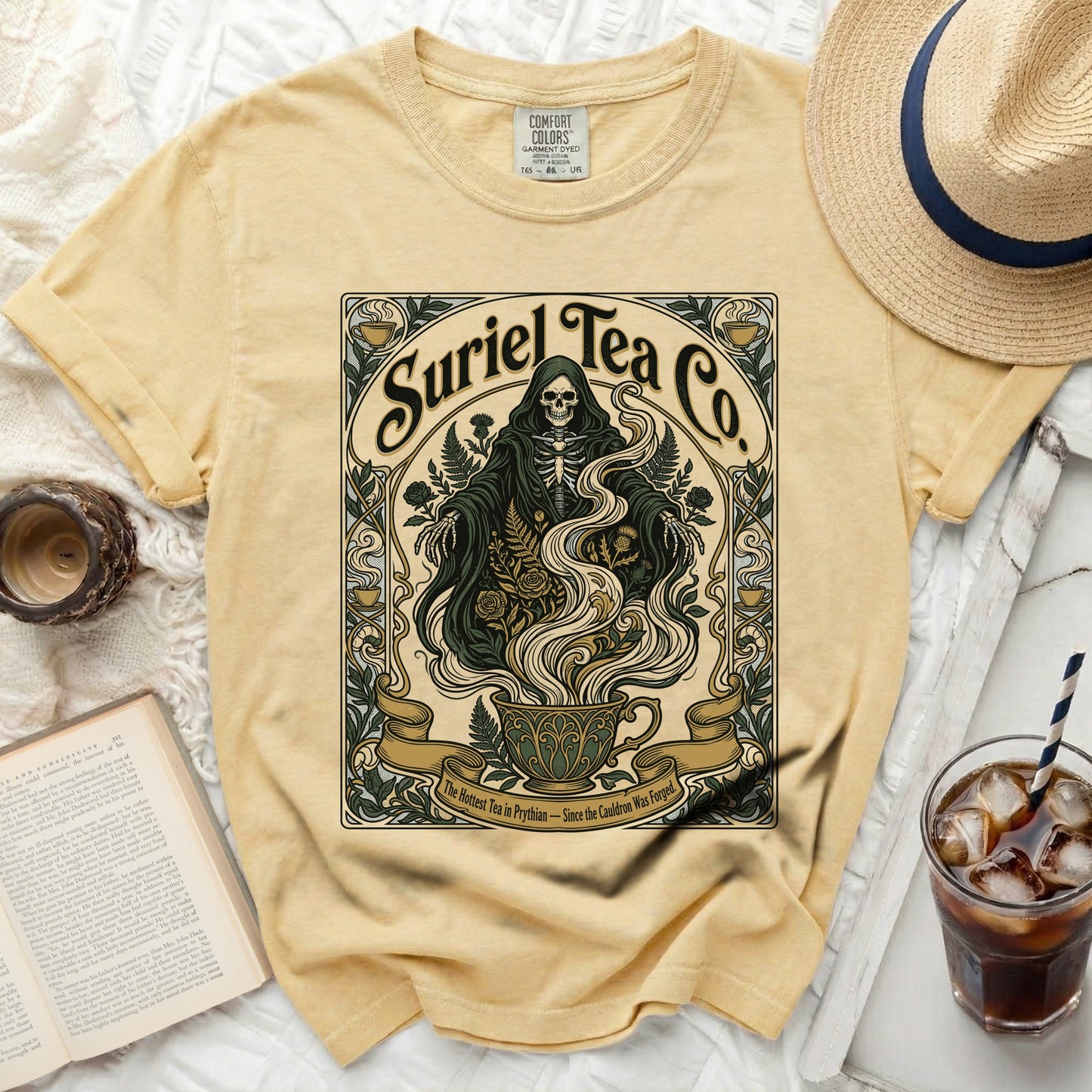 Suriel Tea Co. skeleton graphic on yellow t-shirt with gothic floral design.