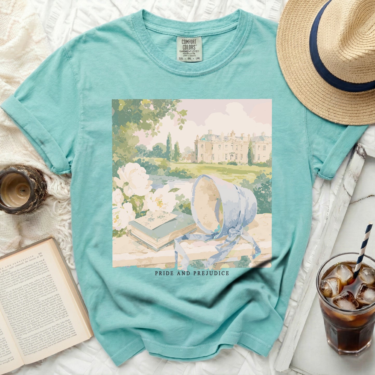 T-shirt with "Pride and Prejudice" graphic featuring books, bonnet, and manor.