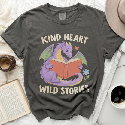 Gray t-shirt with a purple dragon reading a book, "Kind Heart Wild Stories".