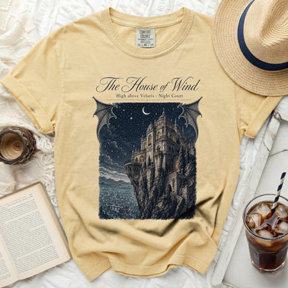 Yellow t-shirt with "The House of Wind" text and castle graphic.