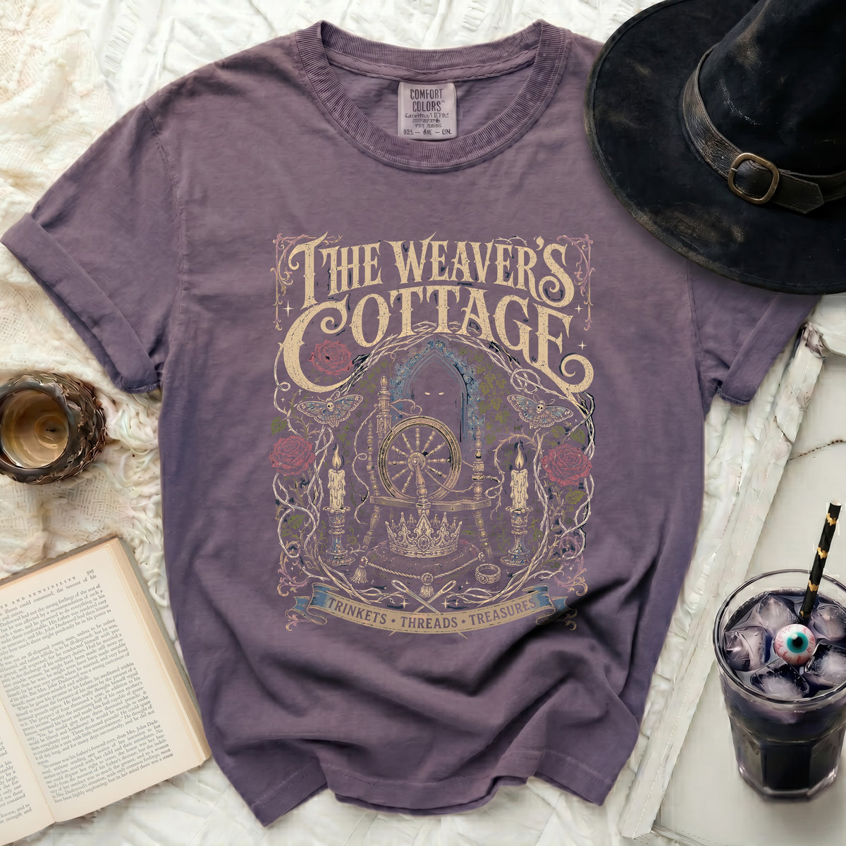 Purple t-shirt with "The Weaver's Cottage" and gothic art.