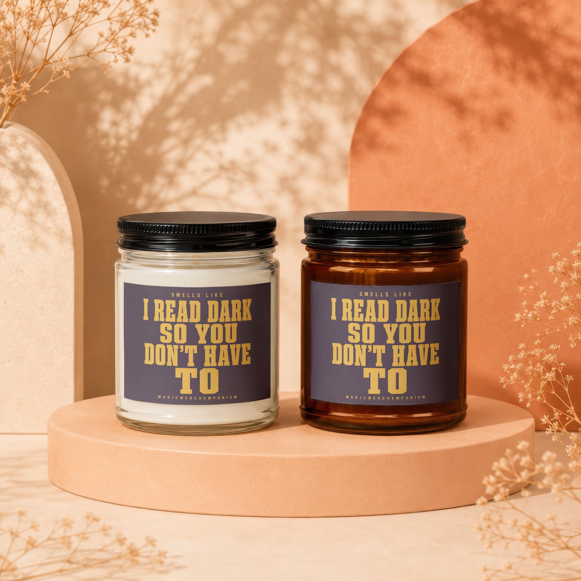Two candles, white and amber, with labels reading "I read dark so you don't have to."