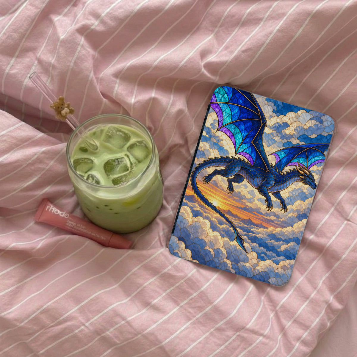 Phone case with blue stained-glass dragon flying through clouds above a sunset.