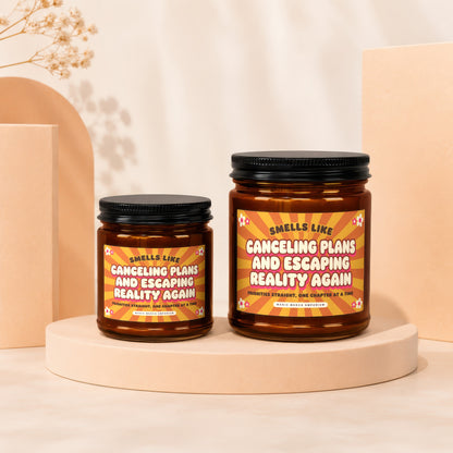 Two candles, one small and one large, with labels reading "Smells Like Canceling Plans and Escaping Reality Again".
