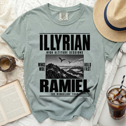 Light blue t-shirt with "ILLYRIAN HIGH ALTITUDE SESSIONS" and "RAMIEL THE RIDGELINE TOUR" text.
