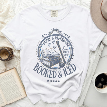 White t-shirt with "Booked & Iced" and hockey imagery.