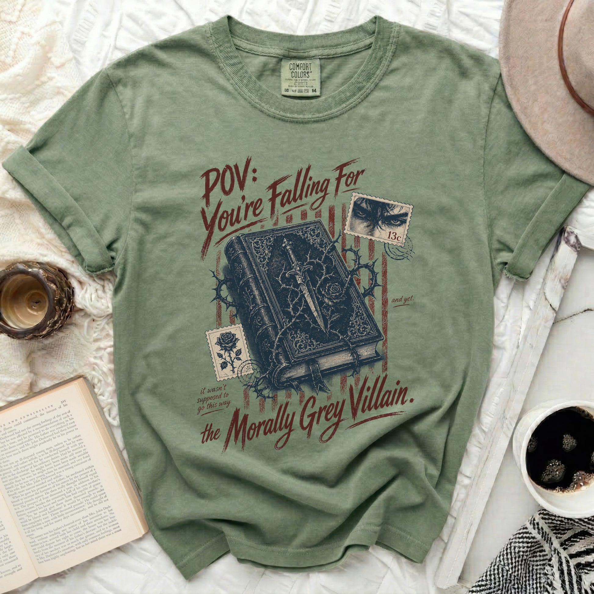 Olive green t-shirt with book, thorns, and "Morally Grey Villain" text.