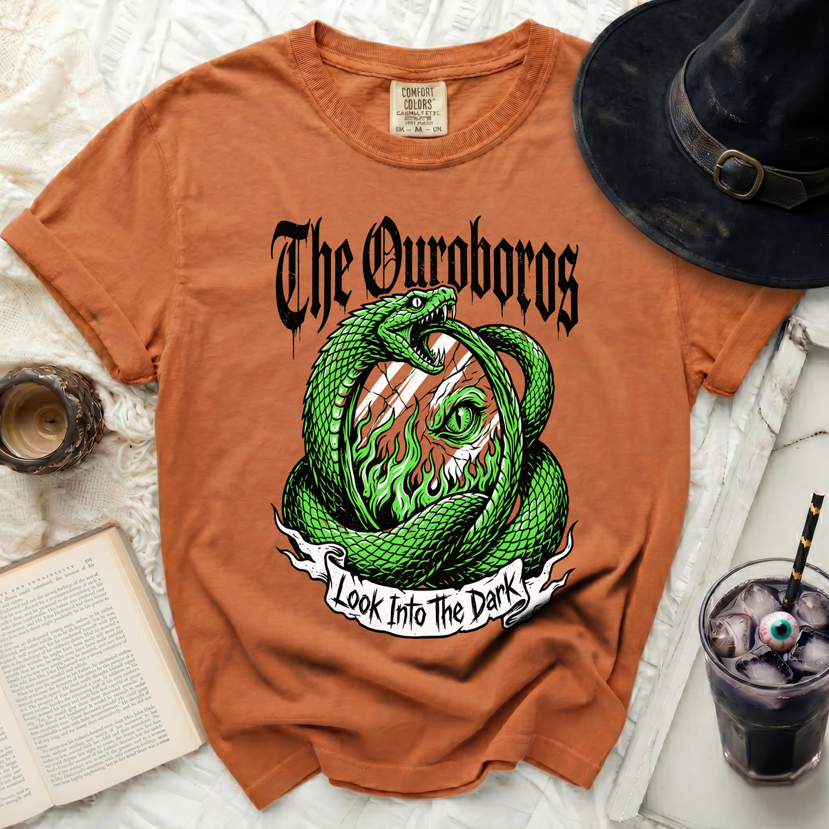 Orange t-shirt with "The Ouroboros" and snake graphic that says "Look Into The Dark".