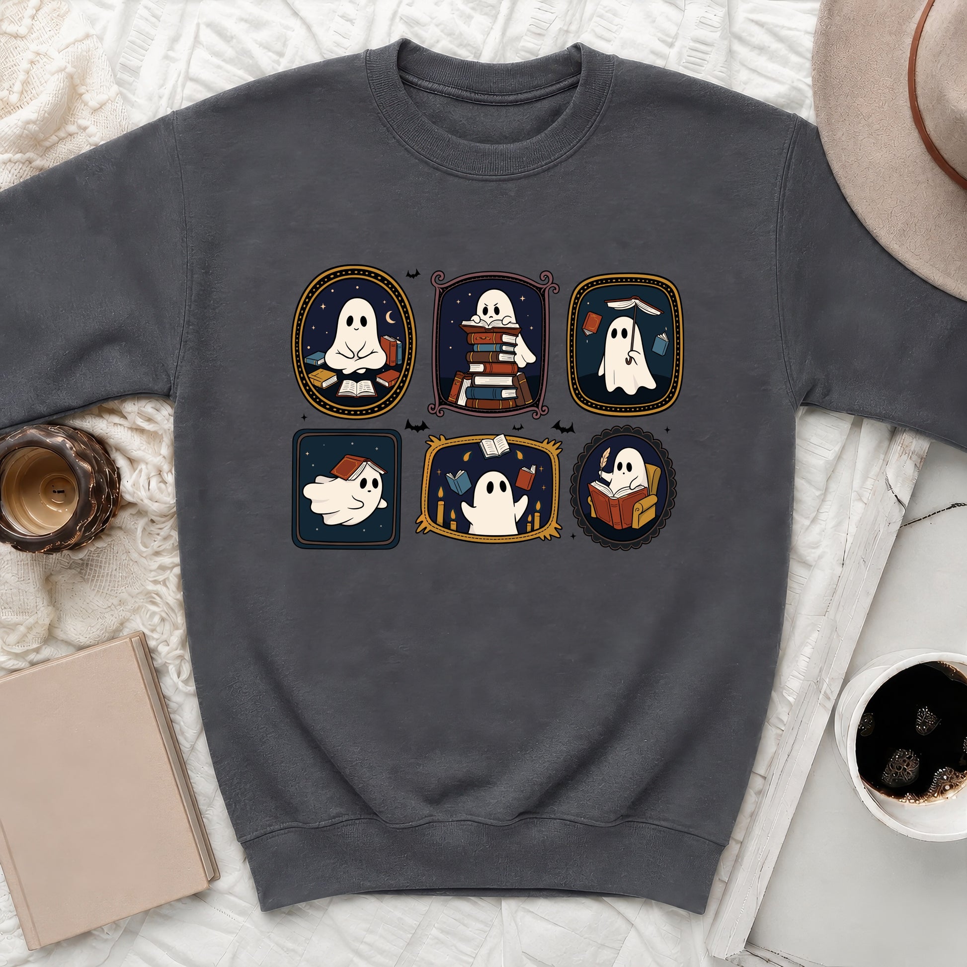Gray sweatshirt with cartoon ghosts interacting with books in framed vignettes.