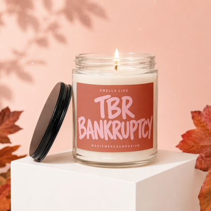 Candle with "Sells Like TBR Bankruptcy" text on label, lid off.