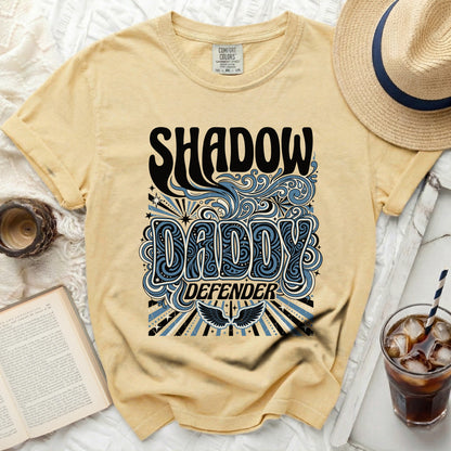 Yellow t-shirt with "Shadow Daddy Defender" graphic and wings.