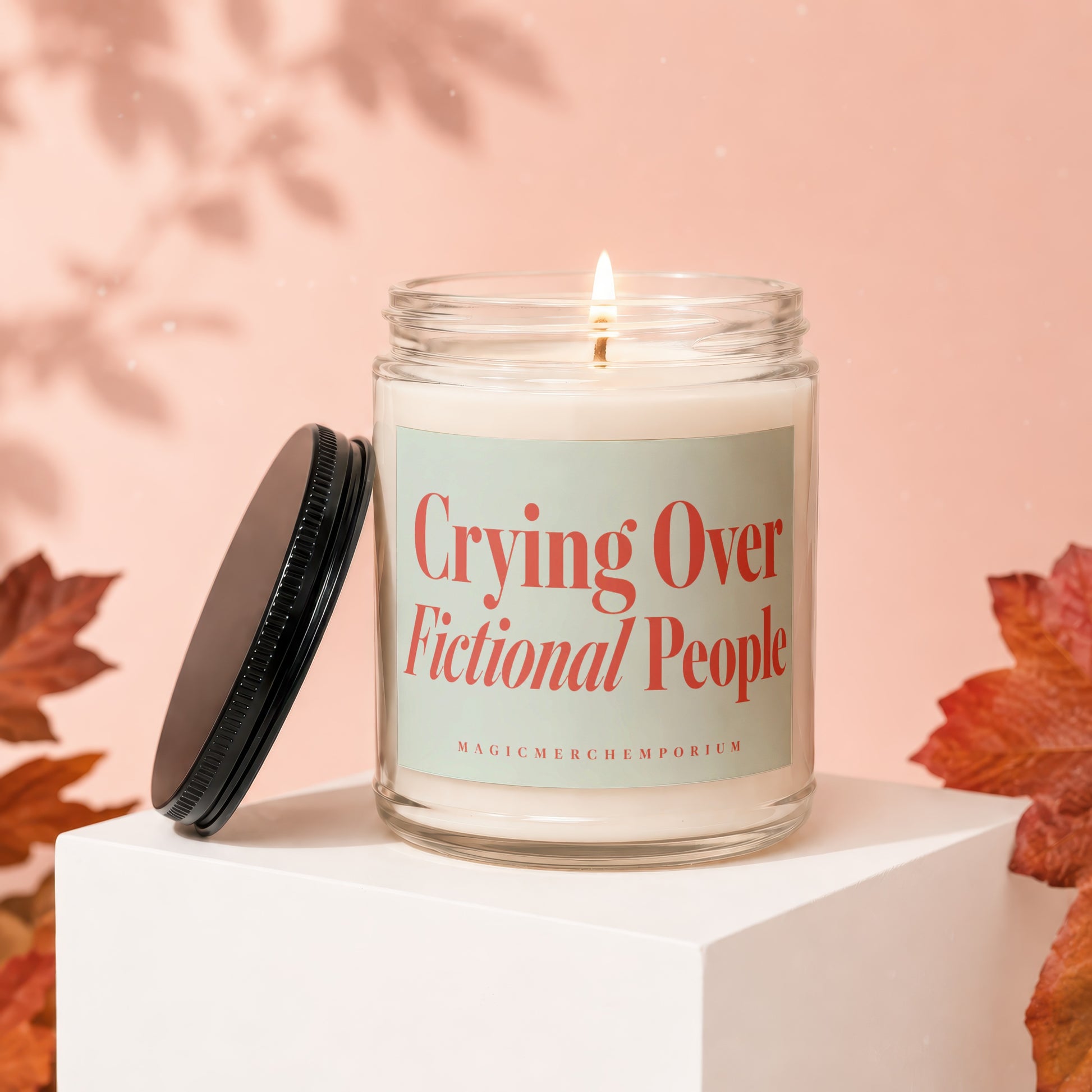 Candle with label "Crying Over Fictional People" and "MagicMerchEmporium" text.