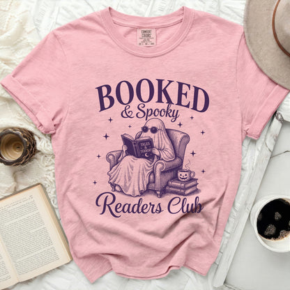 Booked & Spooky Readers Club ghost reading graphic tee.