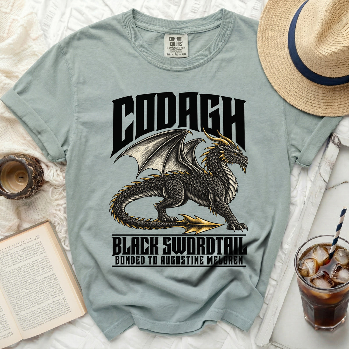 Light blue t-shirt with black dragon graphic and text CODAGH BLACK SWORDTAIL.