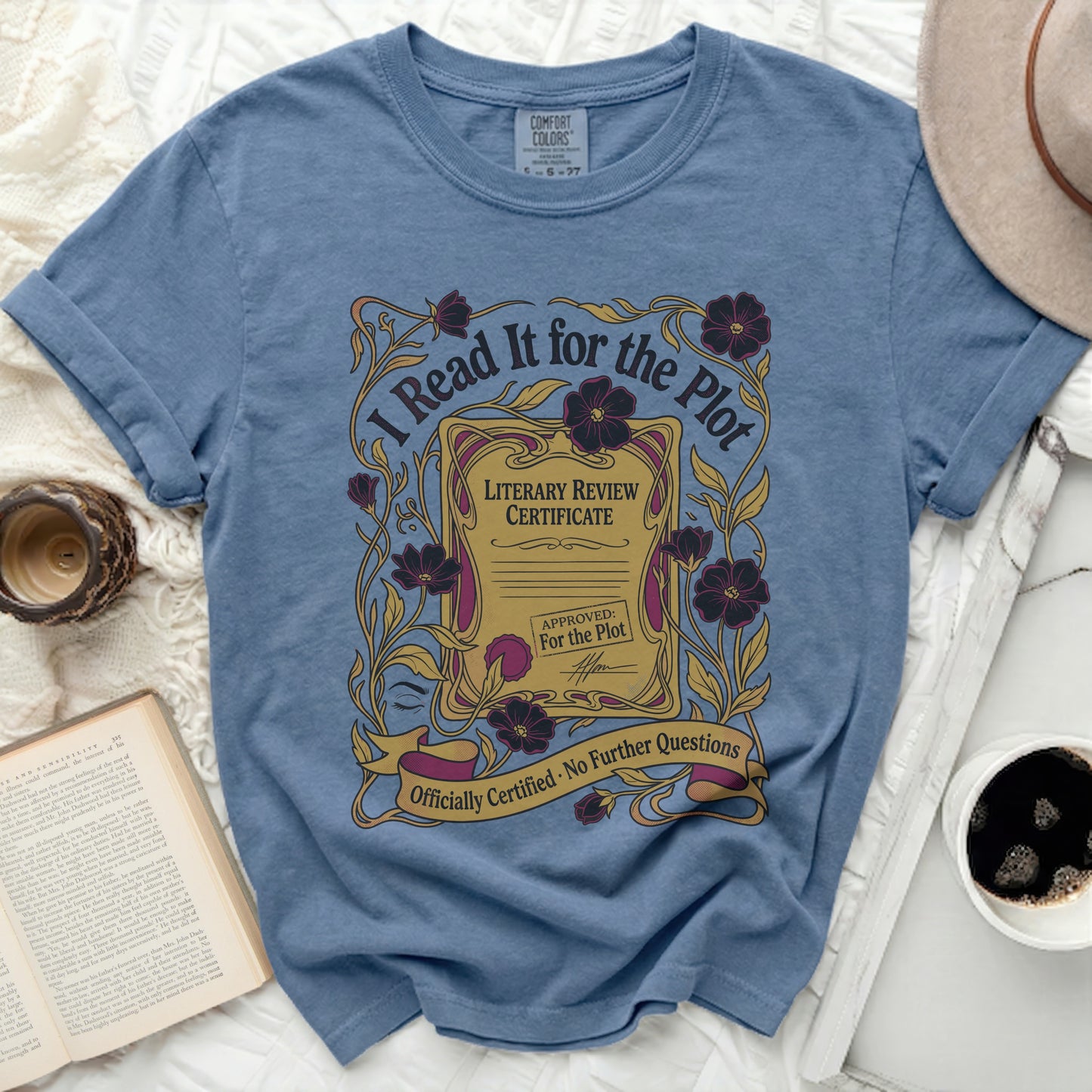 Blue t-shirt with "I Read It for the Plot" literary review certificate graphic.