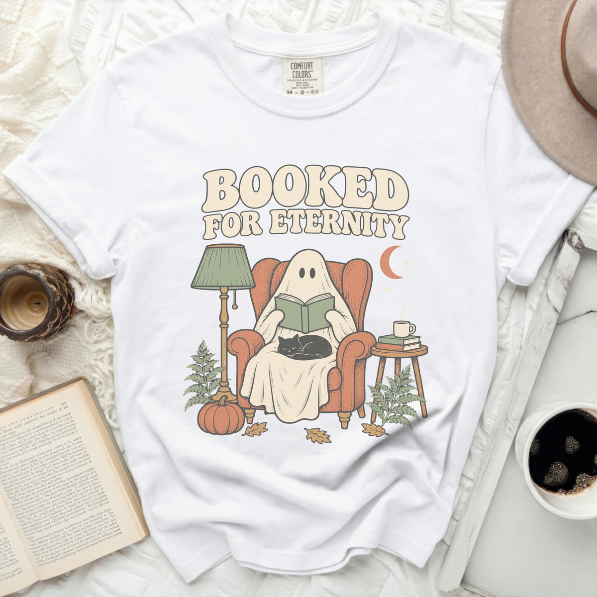 White t-shirt with "Booked For Eternity" graphic featuring a ghost reading.