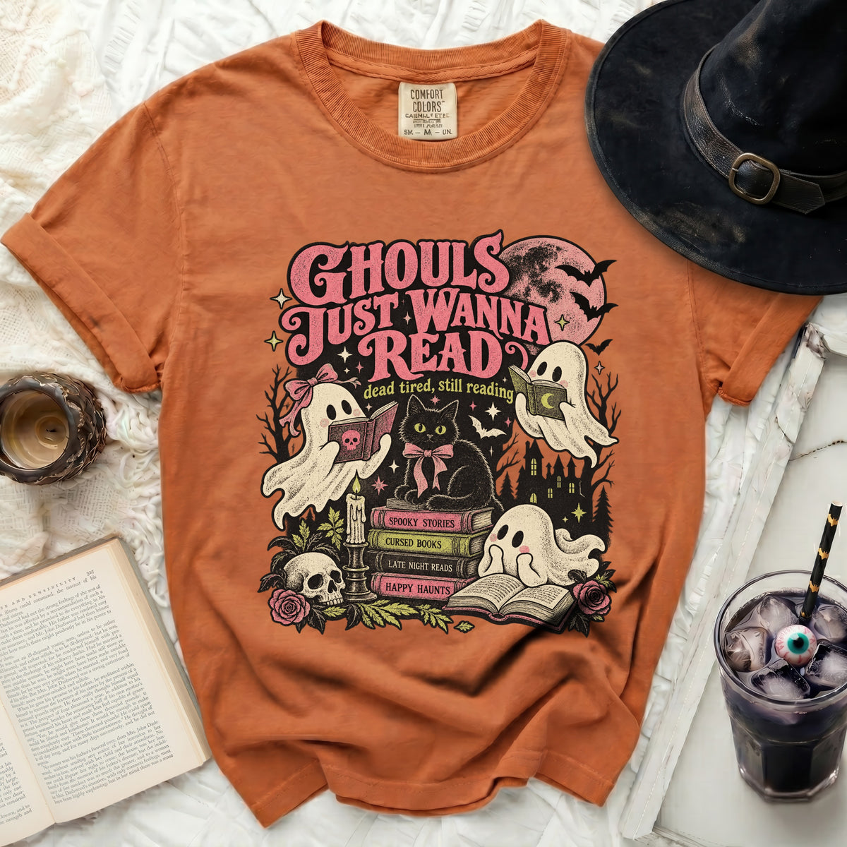 Orange t-shirt with "Ghouls Just Wanna Read" Halloween graphic.
