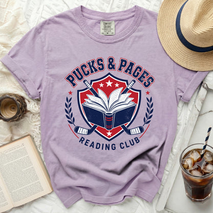Pucks & Pages Reading Club graphic on a purple t-shirt.