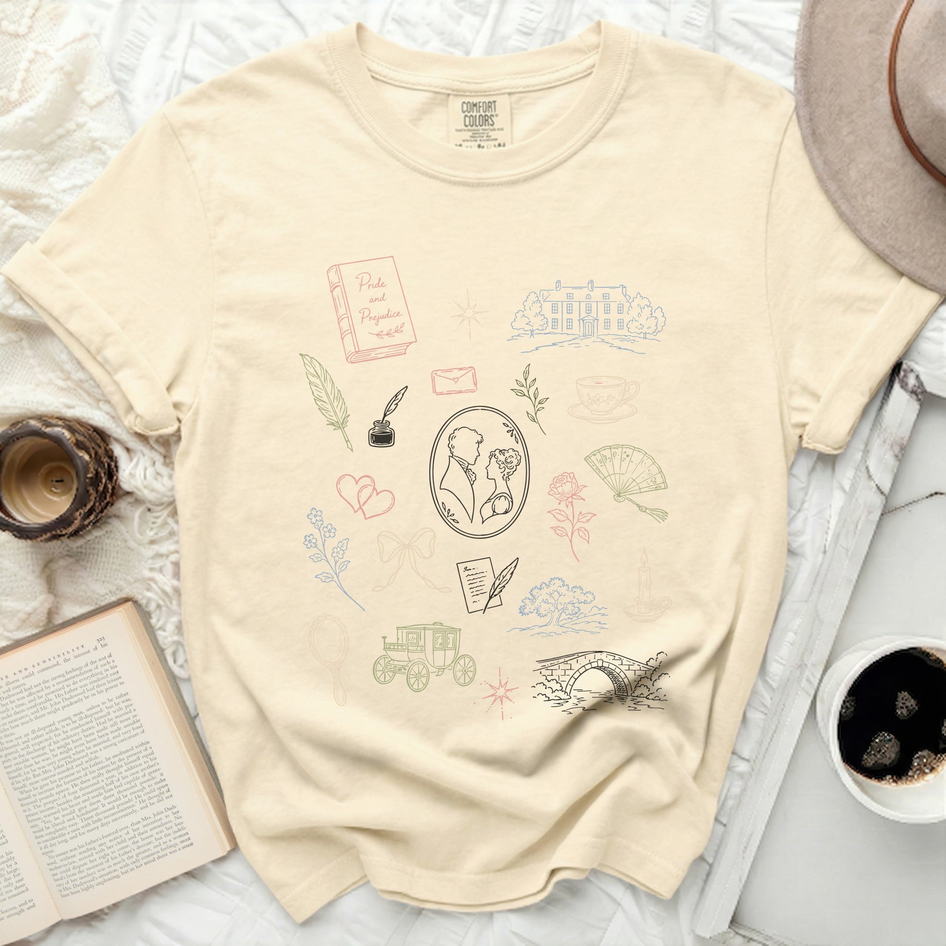 Cream t-shirt with Pride and Prejudice-themed illustrations in line art.