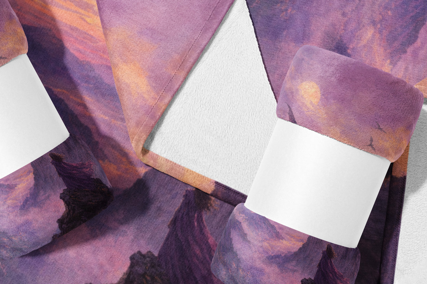 Fuzzy blanket with a purple and orange sky mountain landscape design.