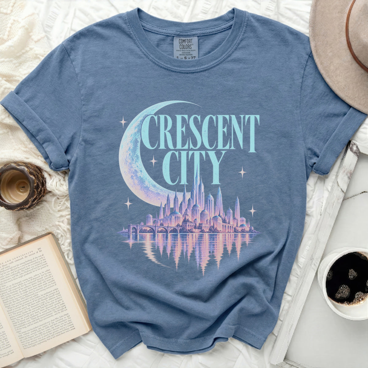 Blue t-shirt with "CRESCENT CITY" text and a crescent moon over a cityscape.