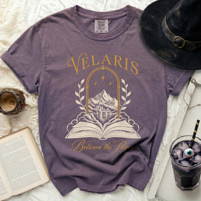 Purple t-shirt with Velaris Between the Pages graphic and open book.
