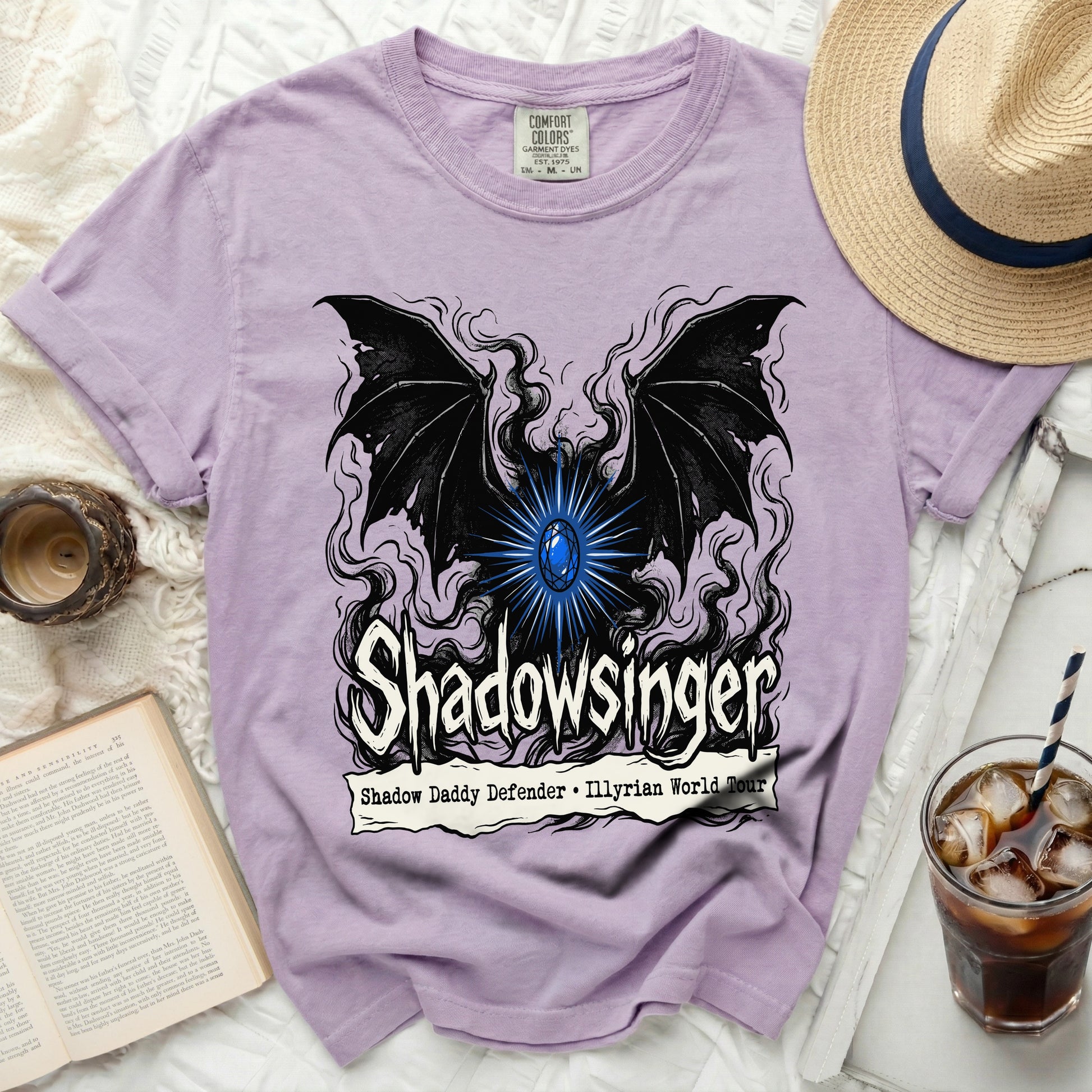 Purple t-shirt with black wings and a blue gem, text: Shadowsinger, Shadow Daddy Defender, Illyrian World Tour.