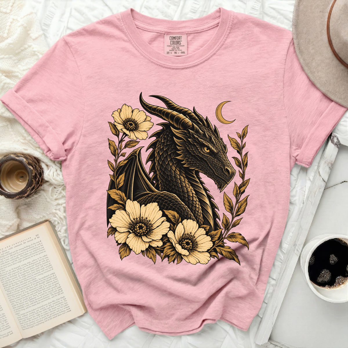 Pink t-shirt with a black dragon and yellow flowers graphic.