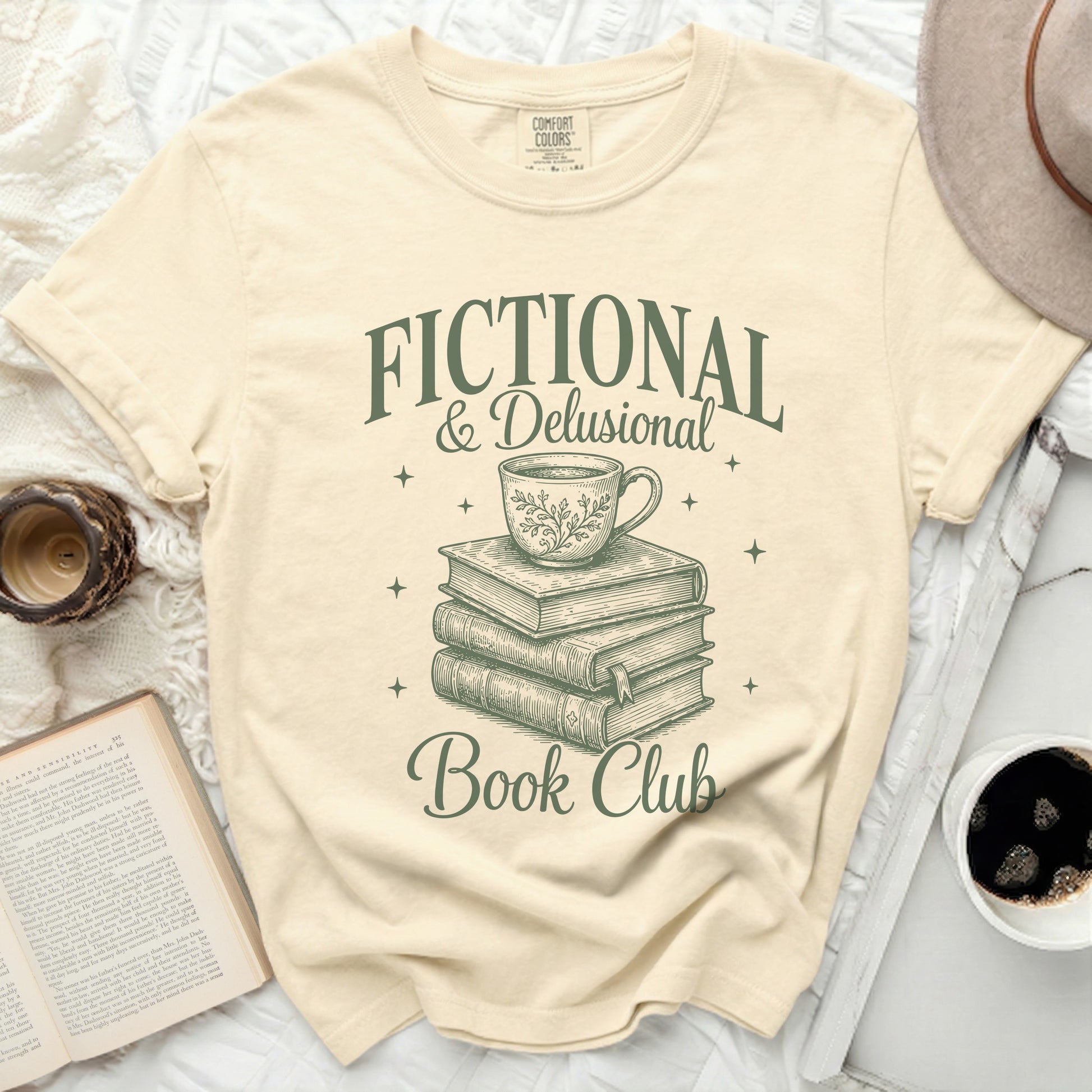 Cream t-shirt with "Fictional & Delusional Book Club" text and illustration.