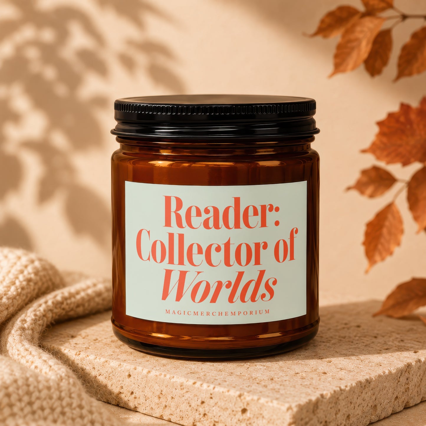 Brown glass candle with label reading "Reader: Collector of Worlds".