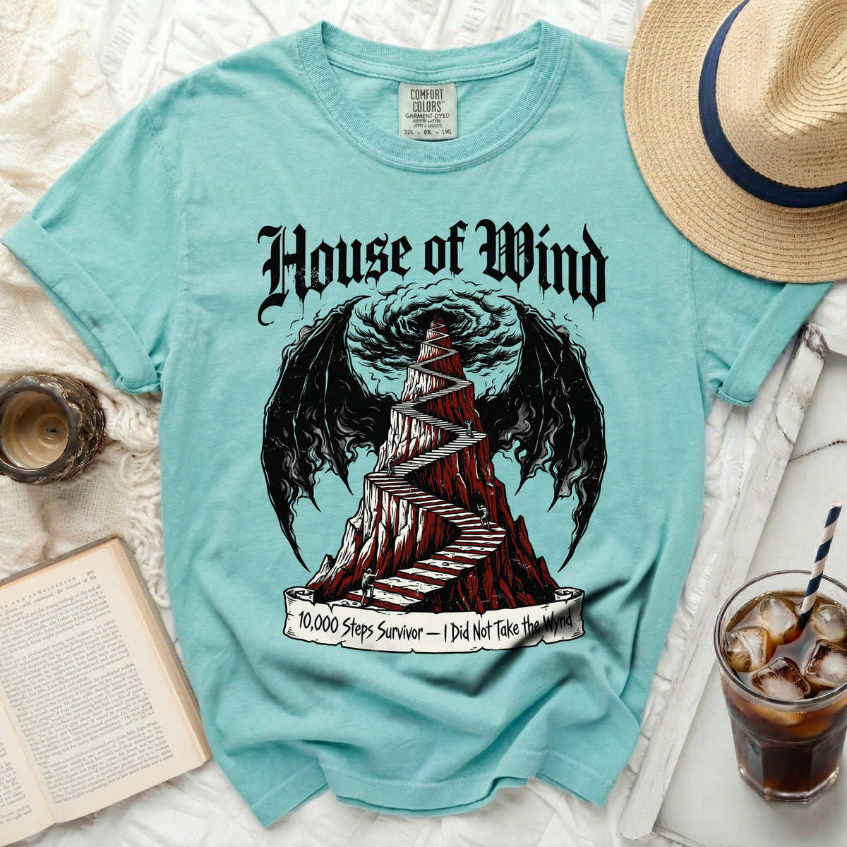 Teal t-shirt with "House of Wind" and winding stairs graphic.