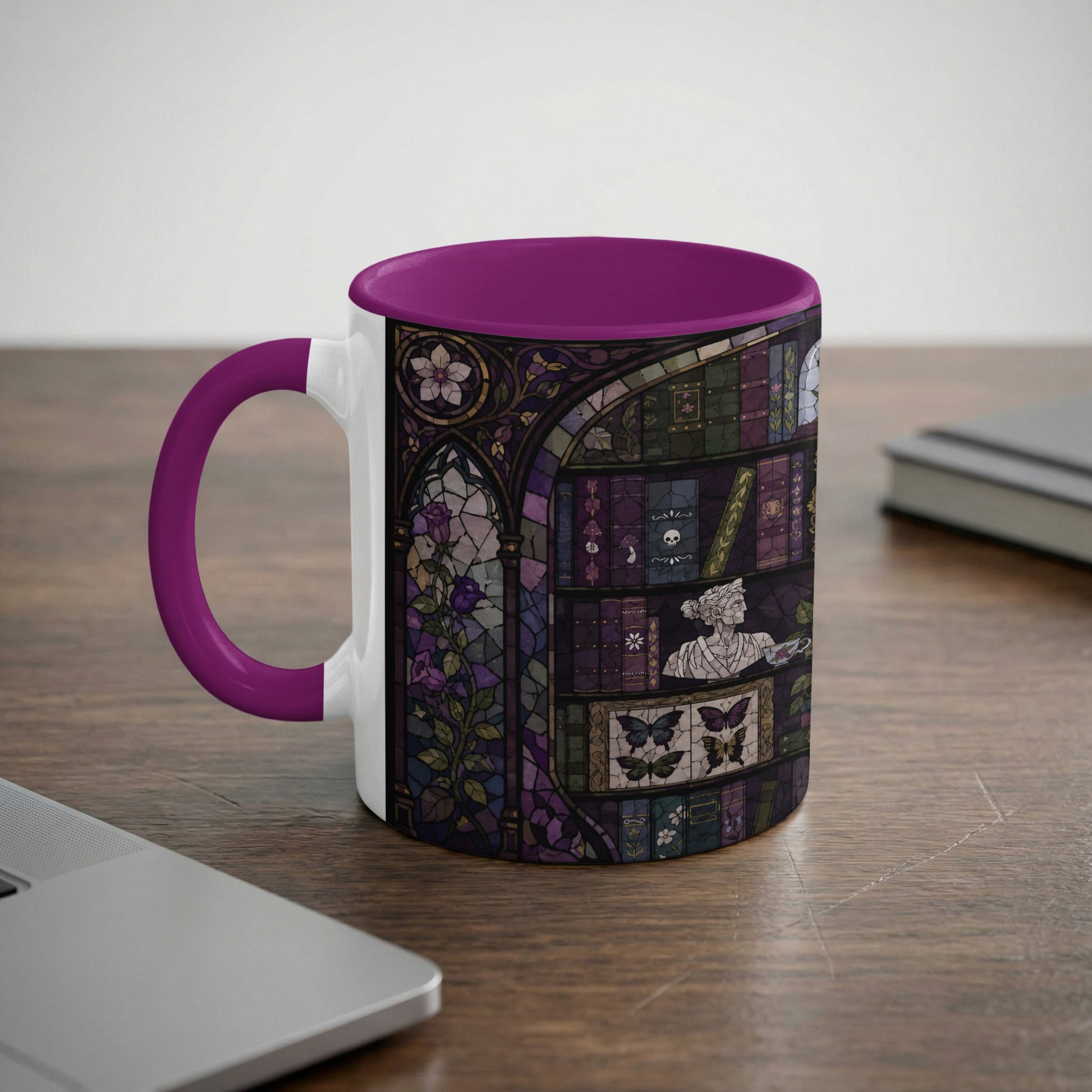 Mug with dark purple handle and interior, featuring stained glass design of books, roses, and butterflies.